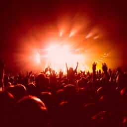 Orange and red view of a concert from behind