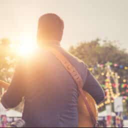 Musician playing at an outdoor music festival.