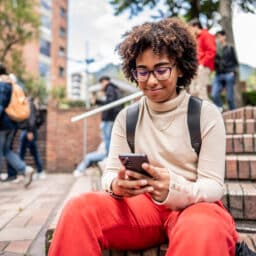 Teenager smiling at her phone