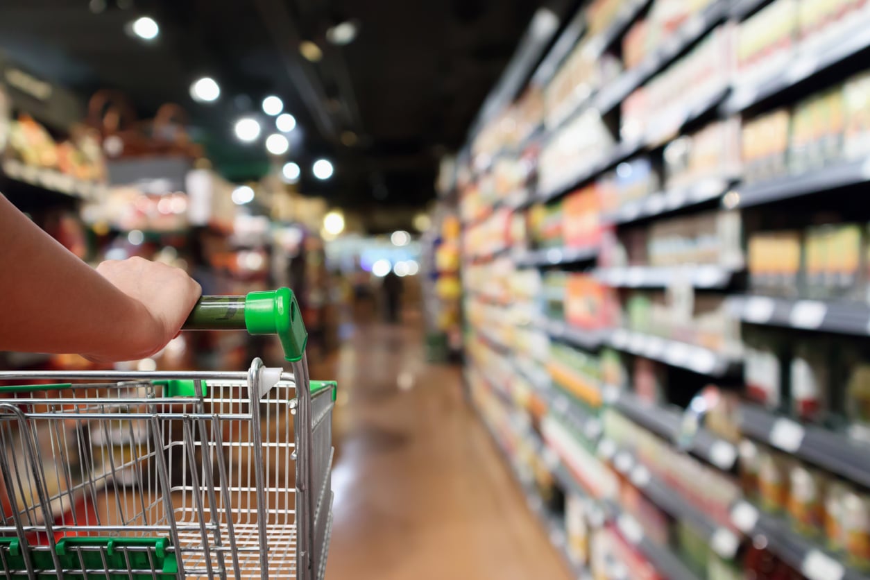 Close-up of a woman pushing cart in supermarket