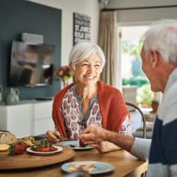 Happy couple eating a healthy breakfast together in the morning.