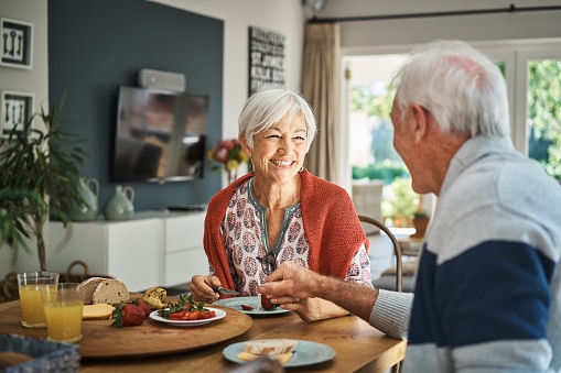 Happy couple eating a healthy breakfast together in the morning.