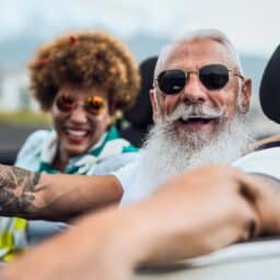 Stylish, smiling couple in a convertible