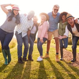 Big group of happy friends posing in a vineyard