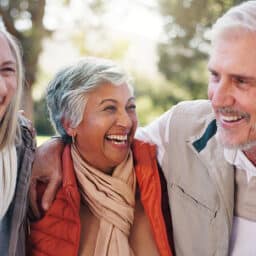 Group of friends laughing and hugging together.
